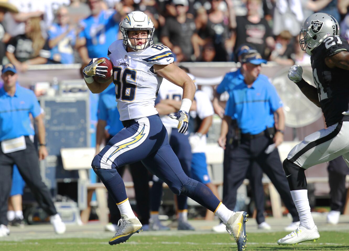 San Diego Chargers Hunter Henry gets taken down by Raiders Sean Smith in the 3rd quarter in Oakland on Oct. 9, 2016. (Photo by K.C. Alfred/The San Diego Union-Tribune)