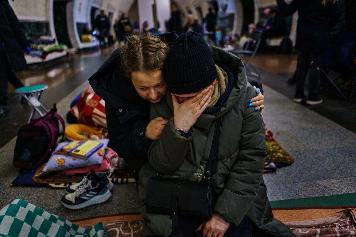 Anastasia Vakulenko consoles Natalya Chikonova as they seek shelter in an underground subway station in Kyiv, Ukraine.
