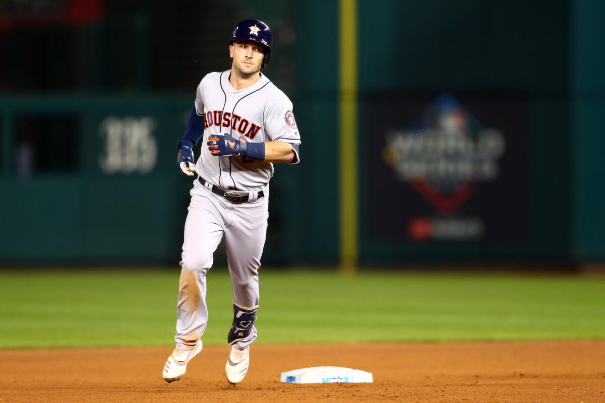 The Astros' Alex Bregman rounds the bases after hitting a seventh-inning grand slam Saturday night.