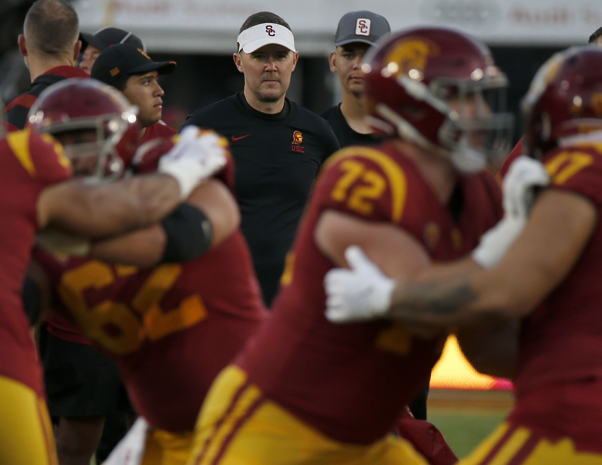 USC coach Lincoln Riley watches his players warm up before a win over Notre Dame at the Coliseum on Nov. 26.
