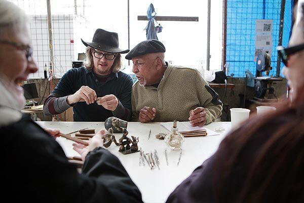 Gordon Bowen, left, shows Richard Lewis, 78, a technique for sculpting wax during a small sculptures workshop at Bowen's Arts Refoundry, outside downtown Los Angeles. The workshop, which cost $150, includes a demo, sculpting time and a final bronze casting, which is ready in 4 to 6 weeks.