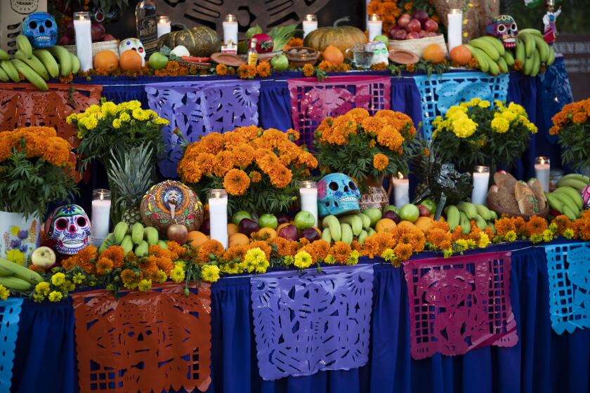 Papel picado on a Dia De Los Muertos ofrenda during media day for Hollywood Forever Cemetery's Dia De Los Muertos celebration in Hollywood, Calif. on Wednesday, Oct. 13. ( Nick Agro / For The Times )