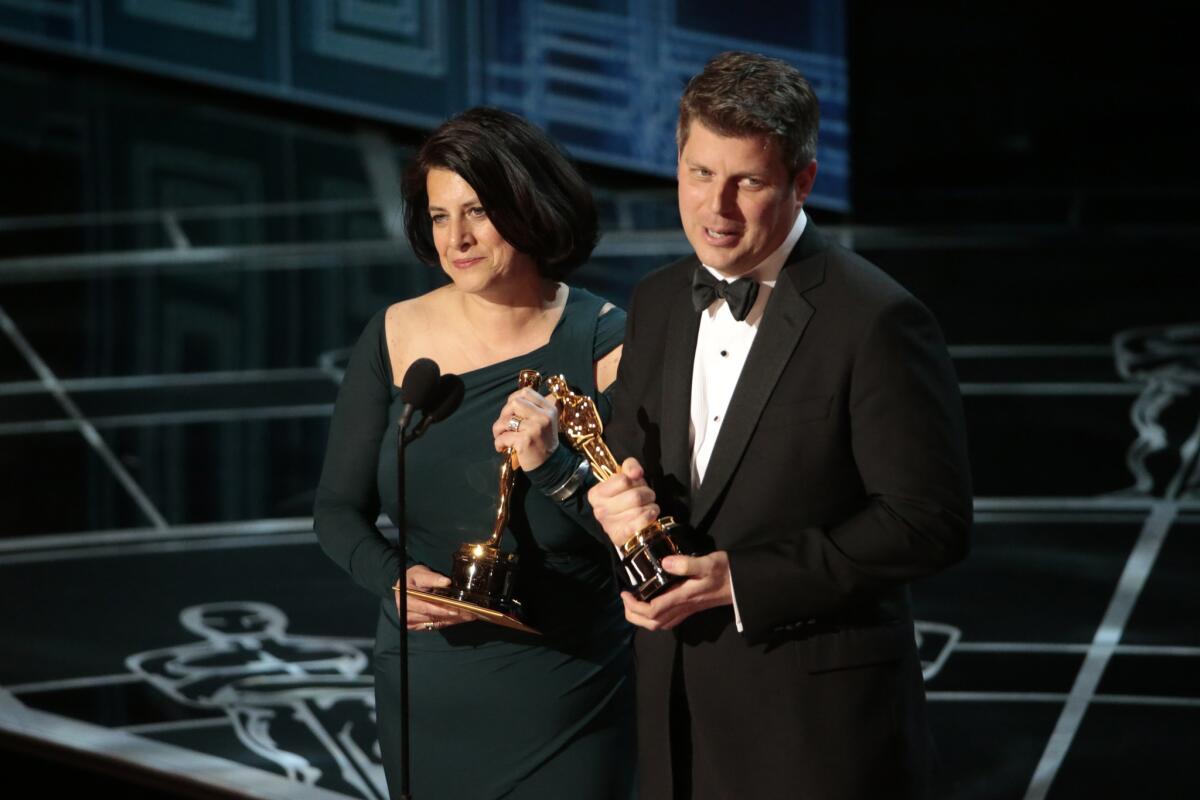 Anna Pinnock (set decoration) and Adam Stockhausen (production design) win Oscars for best production design for "The Grand Budapest Hotel," during the 87th Academy Awards on Feb. 22, 2015.