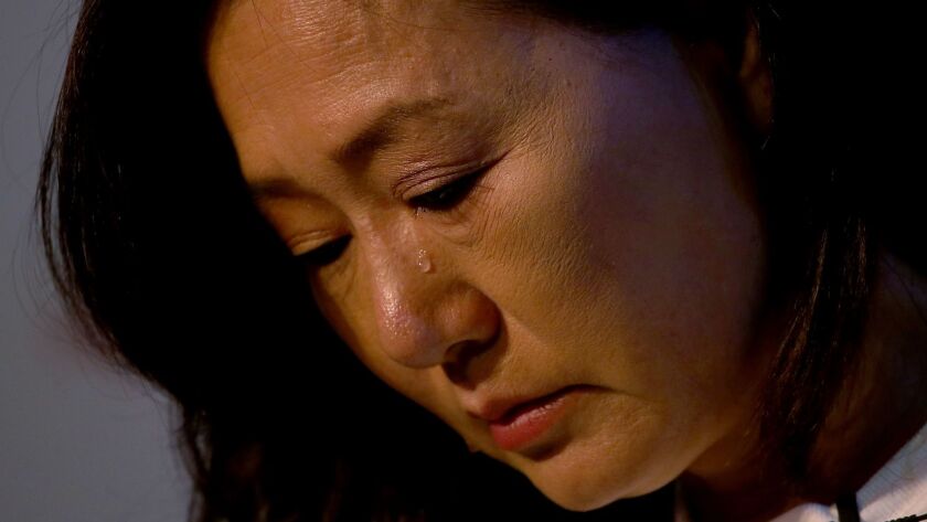 Susan Park, the mother of Elaine Park, who is missing, is overcome by emotion during a news conference Tuesday.