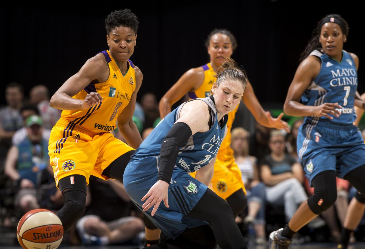 Sparks guard Alana Beard, left, knocks the ball loose while defending Lynx guard Lindsay Whalen (13) during the second quarter.