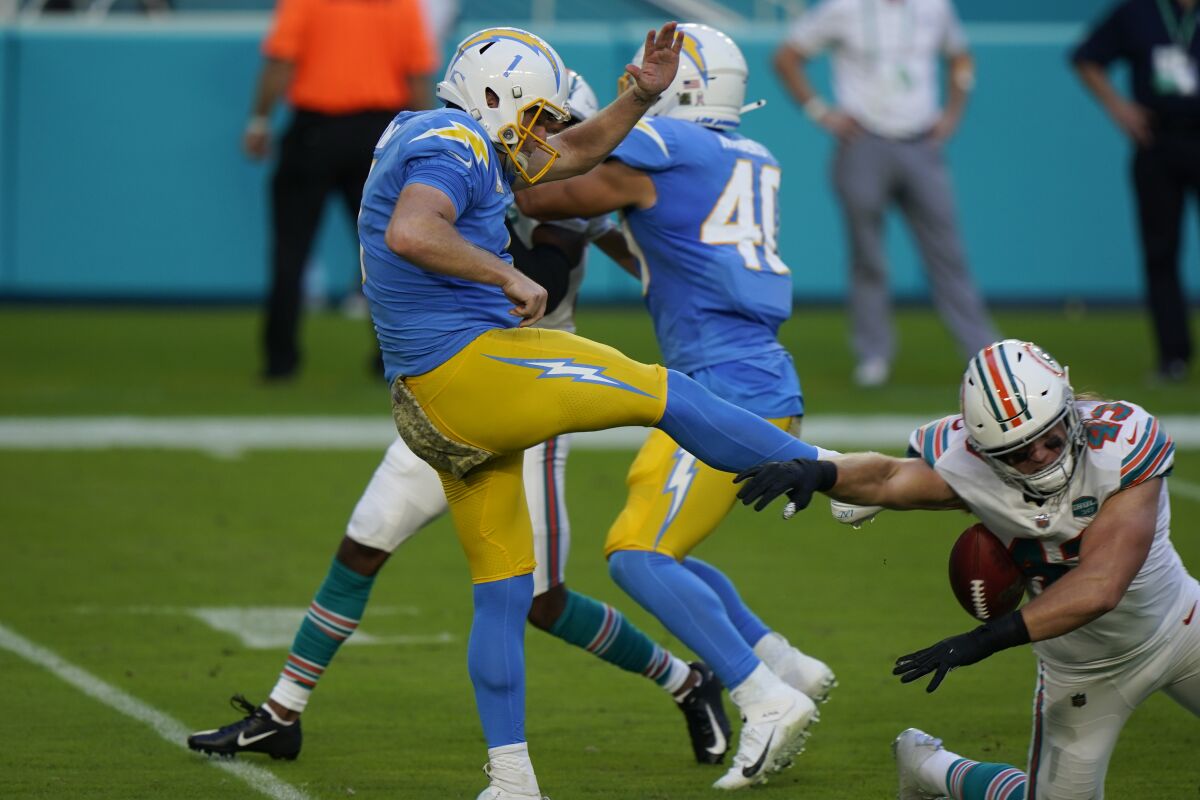 Miami Dolphins outside linebacker Andrew Van Ginkel blocks a punt by Chargers punter Ty Long.