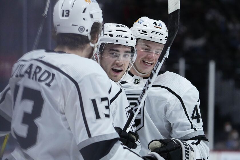 Los Angeles Kings defenseman Sean Walker (26) celebrates a goal with teammates Gabriel Vilardi (13) and Drake Rymsha (43) against the Colorado Avalanche during the first period of an NHL hockey game Thursday, May, 13, 2021, in Denver. (AP Photo/Jack Dempsey)