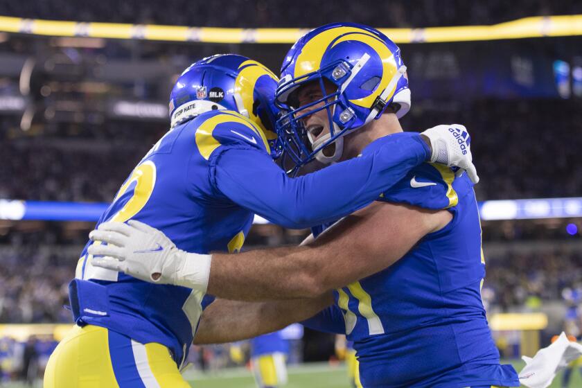 Los Angeles Rams inside linebacker Troy Reeder (51) celebrates an interception by defensive back David Long (22) during an NFL wild-card playoff football game against the Arizona Cardinals Monday, Jan. 17, 2022, in Inglewood, Calif. (AP Photo/Kyusung Gong)