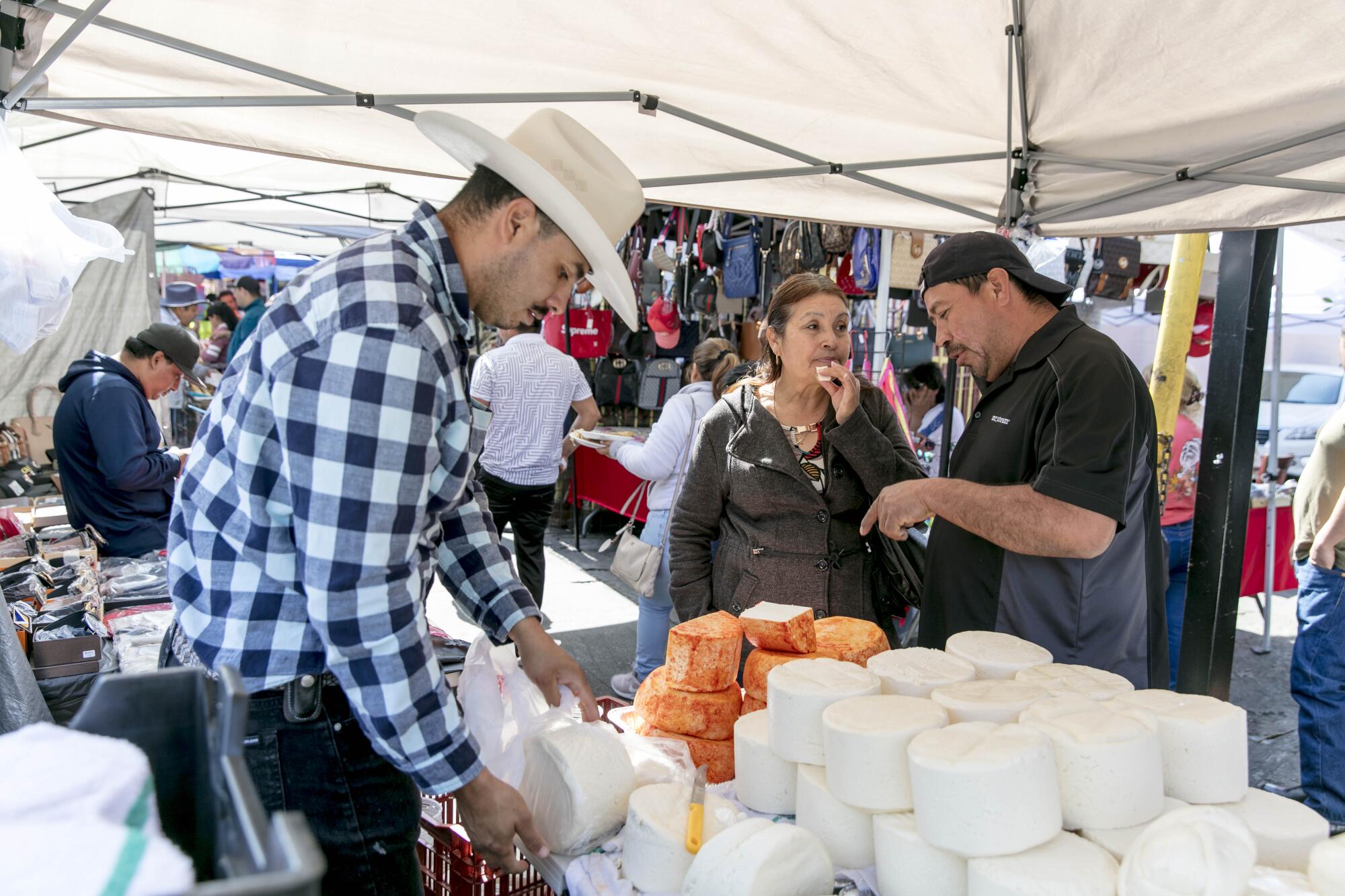 Ivan Tapia, left, sells Jalisco-style cheese.