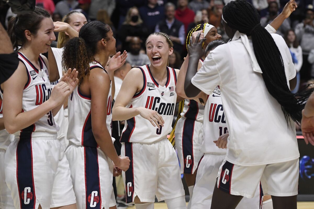 Connecticut's Paige Bueckers (5) and teammates celebrate their win against Villanova in an NCAA college basketball game in the Big East tournament final at Mohegan Sun Arena, Monday, March 7, 2022, in Uncasville, Conn. (AP Photo/Jessica Hill)
