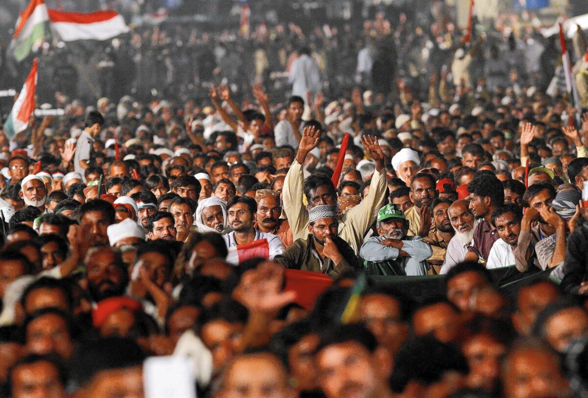 Followers listen to a speech by protest leader Tahirul Qadri, a moderate cleric, outside the parliament in Islamabad, Pakistan.