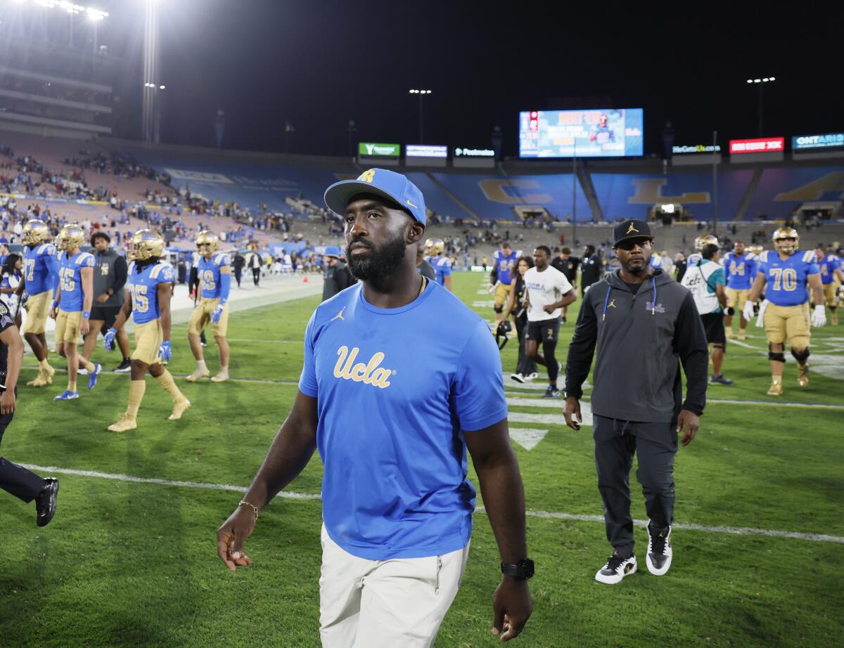 UCLA coach DeShaun Foster walks off the field following UCLA's blowout loss to Indiana at the Rose Bowl on Saturday.