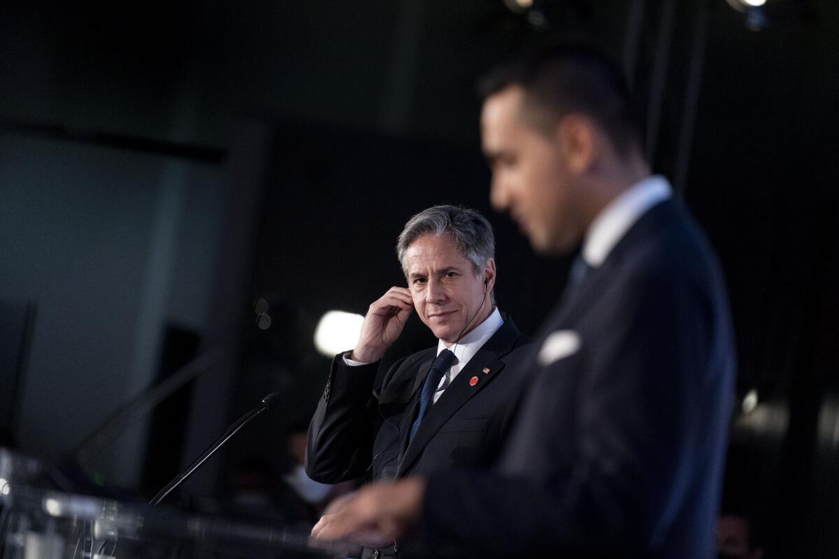 Secretary of State Antony J. Blinken listens as Italy's Foreign Minister Luigi Di Maio speaks during a news conference.