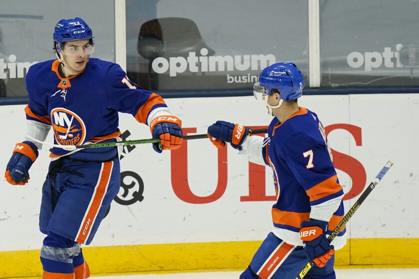 New York Islanders' Mathew Barzal (13) celebrates with Jordan Eberle (7) after scoring a goal during the third period of an NHL hockey game against the New Jersey Devils Saturday, May 8, 2021, in Uniondale, N.Y. The Islanders won 5-1. (AP Photo/Frank Franklin II)