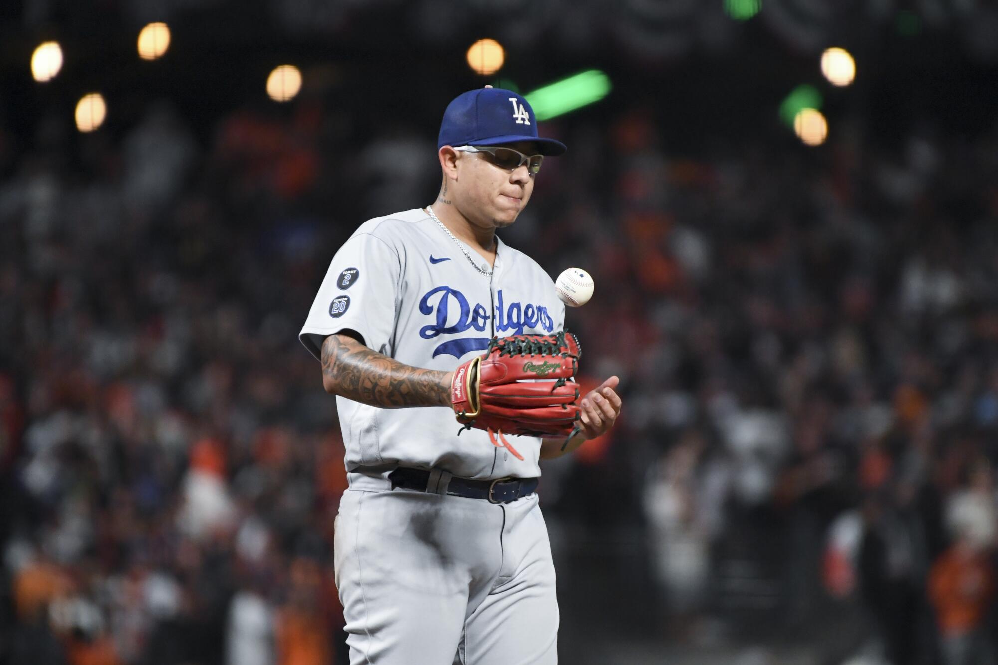 Dodgers pitcher Julio Urias tosses the ball on the mound after allowing a solo home run to Giants' Darin Ruf