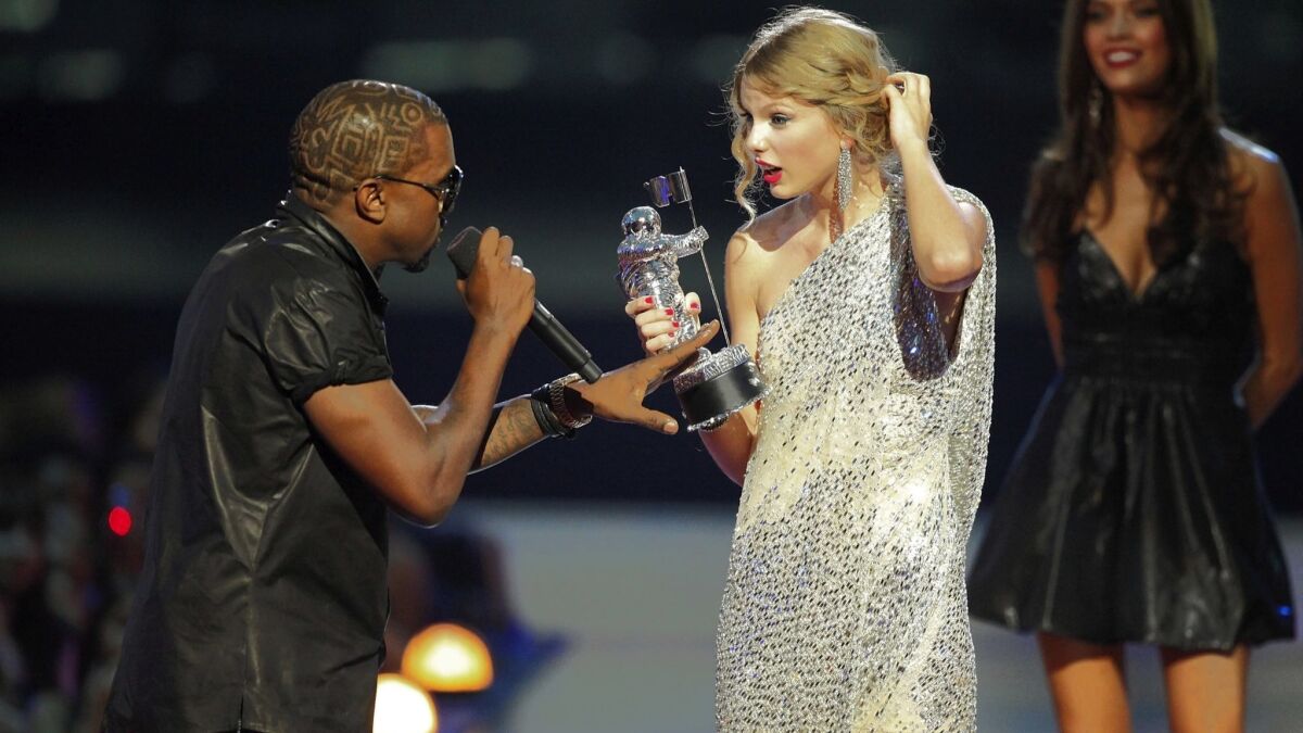 Kayne West jumps onstage after Taylor Swift won the female video award during the 2009 MTV Video Music Awards. Now, their beef has moved into the political arena.