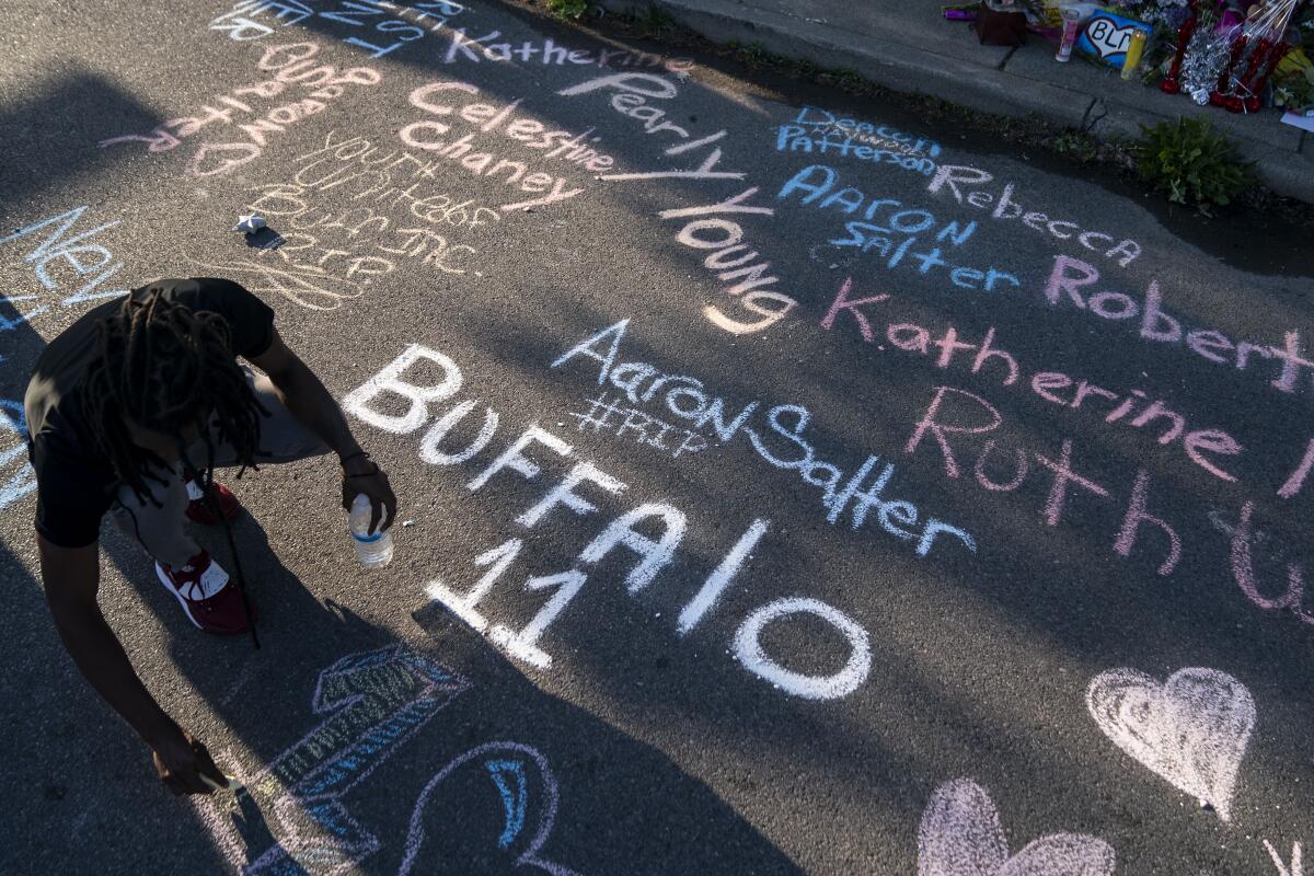 A sidewalk mural depicts the names of people killed in the Buffalo shooting.