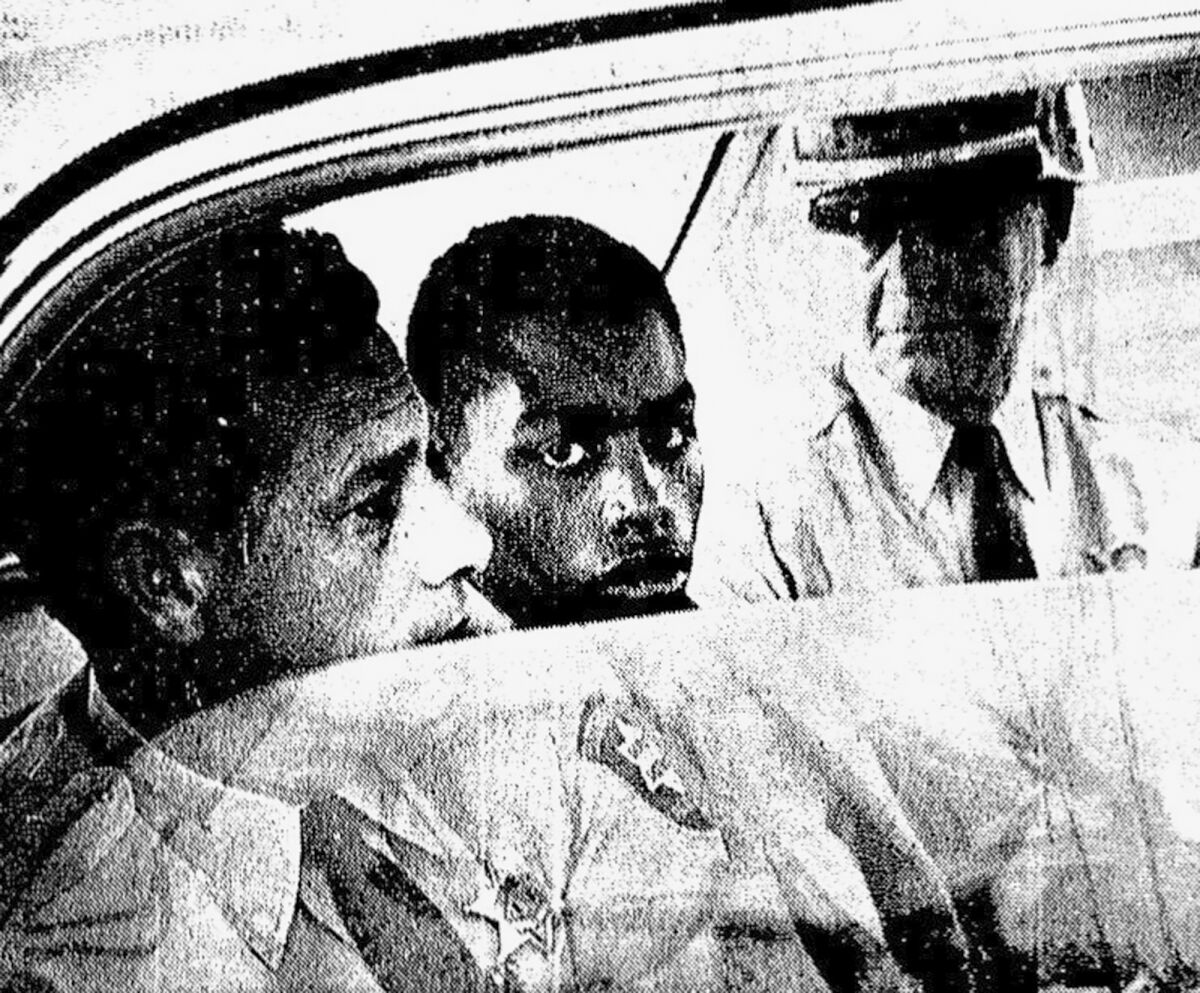 FILE - In this February 1964 photo, Henry Montgomery, flanked by two deputies, awaits the verdict in his trial for the murder of Deputy Sheriff Charles H. Hurt in Louisiana. On Wednesday, Nov. 17, 2021, a Louisiana parole board votes for the third time whether to grant Montgomery parole. Montgomery's supporters say he's fully reformed and deserves to be freed. (John Boss/The Advocate via AP, File)