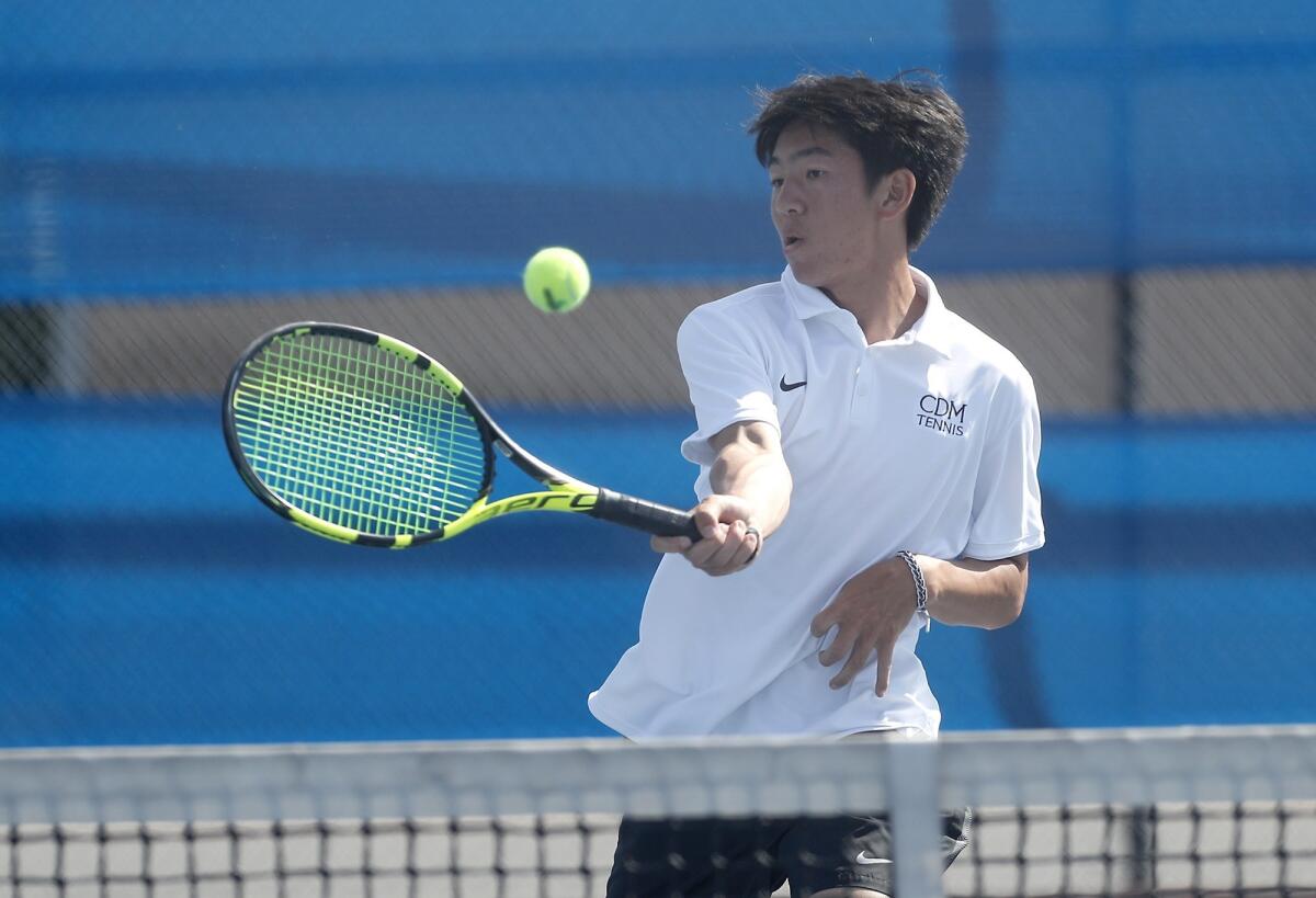Corona del Mar High's Kyle Pham scores at the net against Fountain Valley in a No. 1 singles set during a Surf League match at Fountain Valley on Tuesday.