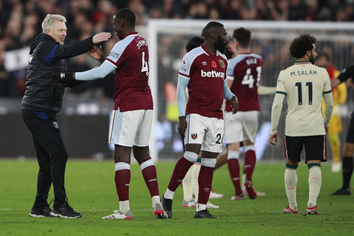 West Ham's manager David Moyes hugs players at the end of the English Premier League soccer match between West Ham United and Liverpool at the London stadium in London, England, Sunday, Nov. 7, 2021. (AP Photo/Ian Walton)