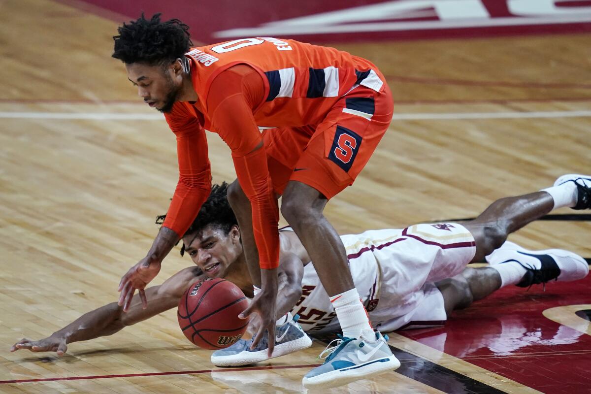 Boston College guard Demarr Langford Jr. (15) dives but Syracuse forward Alan Griffin (0) controls the ball during the second half of an NCAA college basketball game, Saturday, Dec. 12, 2020, in Boston. Syracuse won 101-63. (AP Photo/Elise Amendola)