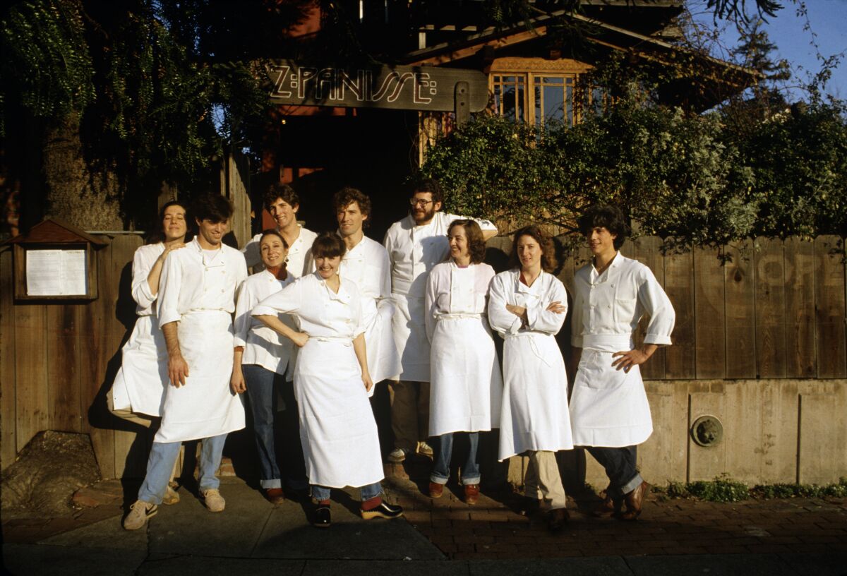 Alice Waters (center) poses outside Chez Panisse with her kitchen staff in 1982. (Photo by Susan Wood/Getty Images)