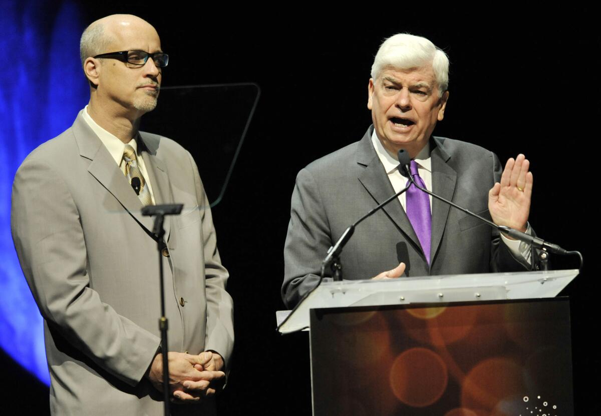 National Assn. of Theatre Owners President and Chief Executive John Fithian, left, joins Christopher Dodd, chairman and CEO of the Motion Picture Assn. of America, at CinemaCon 2013's State of the Industry address at Caesars Palace in Las Vegas.