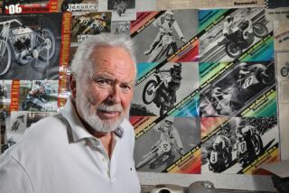 June 28, 2017_Fallbrook, California_USA_| Portrait of motorcycle frame builder Jeff Cole, 76, in his home garage workshop. In the background are some of his large collection of posters and photos of prominent motorcycle racers on bikes he designed. |_Photo Credit: Photo by Charlie Neuman