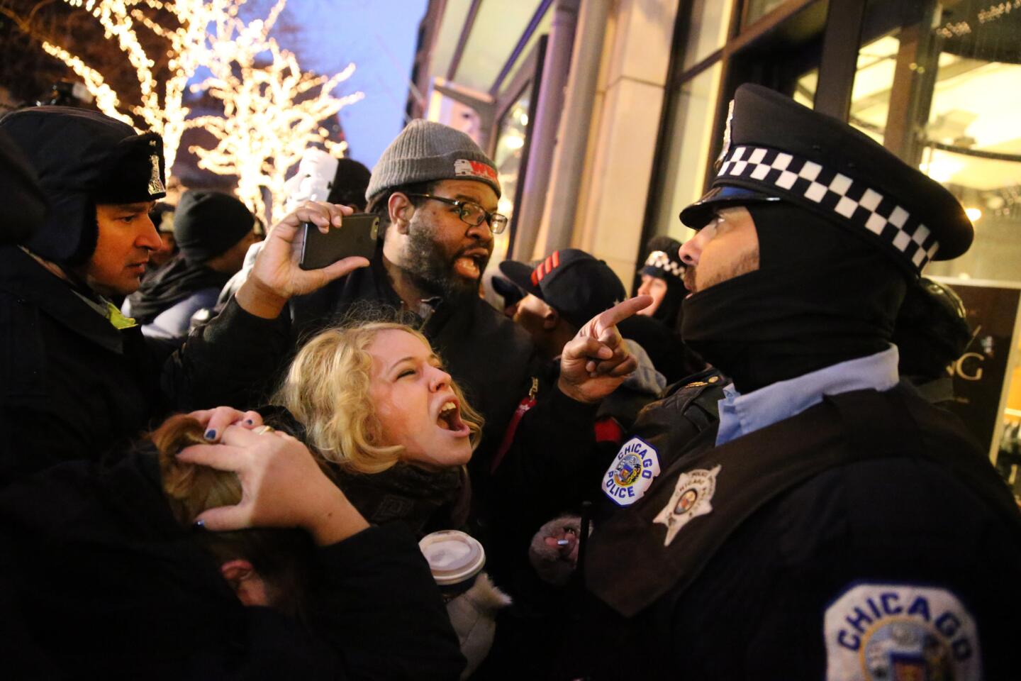 Protesters shout at a police officer on Nov. 27, 2015, as marchers gathered on North Michigan Avenue to express outrage over the shooting death of Laquan McDonald.