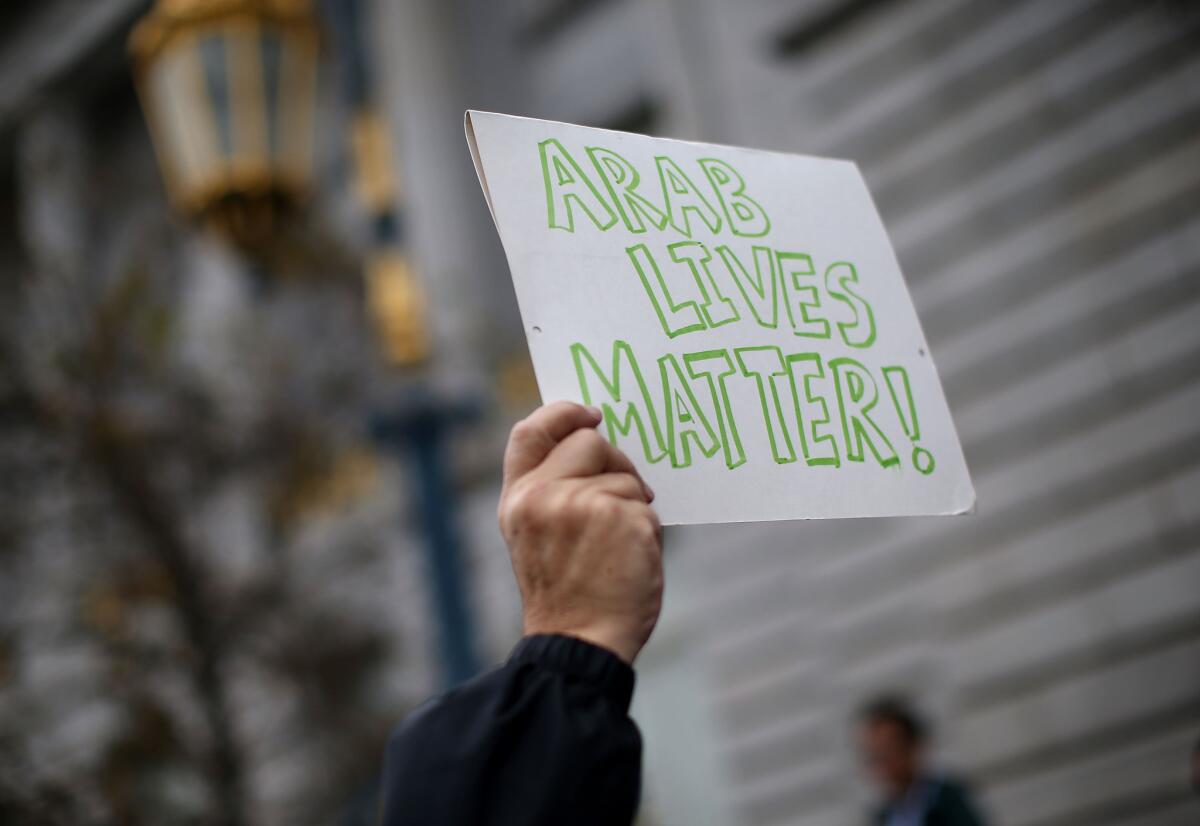 A protestor holds a sign during a demonstration denouncing racist attacks against Muslims on Dec. 18 in San Francisco.