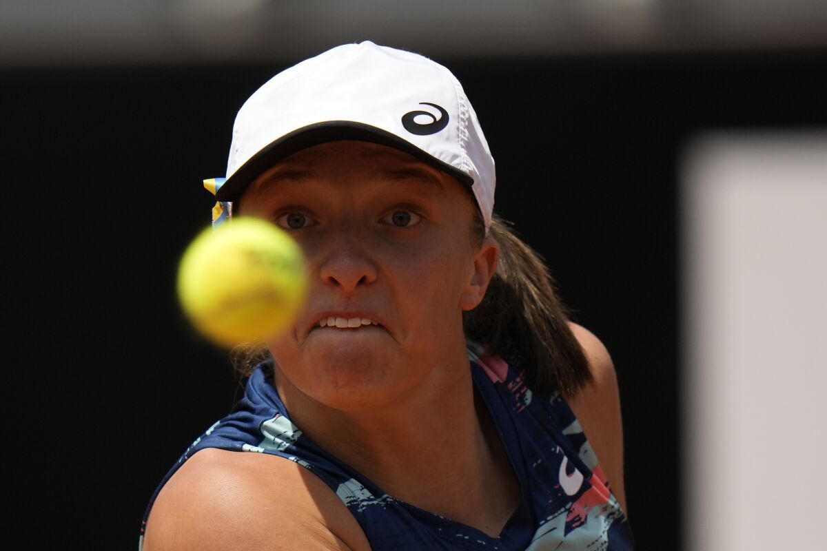 Poland's Iga Swiatek returns the ball to Turkey's Ons Jabeur during their final match at the Italian Open tennis tournament, in Rome, Sunday, May 15, 2022. (AP Photo/Alessandra Tarantino)