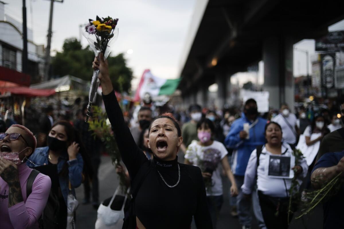 A woman shouts during a march demanding justice for the people who died in Monday's subway collapse
