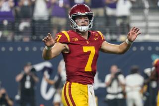 USC Trojans quarterback Miller Moss raises his hands and directs the offense during the team's win over LSU