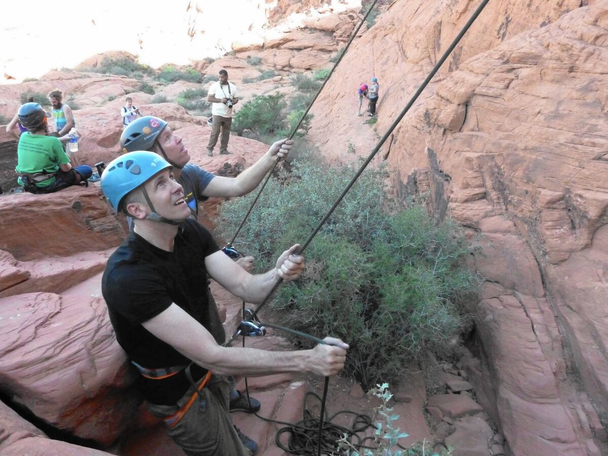 At the Red Rock Canyon National Conservation Area outside Las Vegas, Mike Tupper, foreground, helps lead a climbing tutorial for children of U.S. service members killed in action.