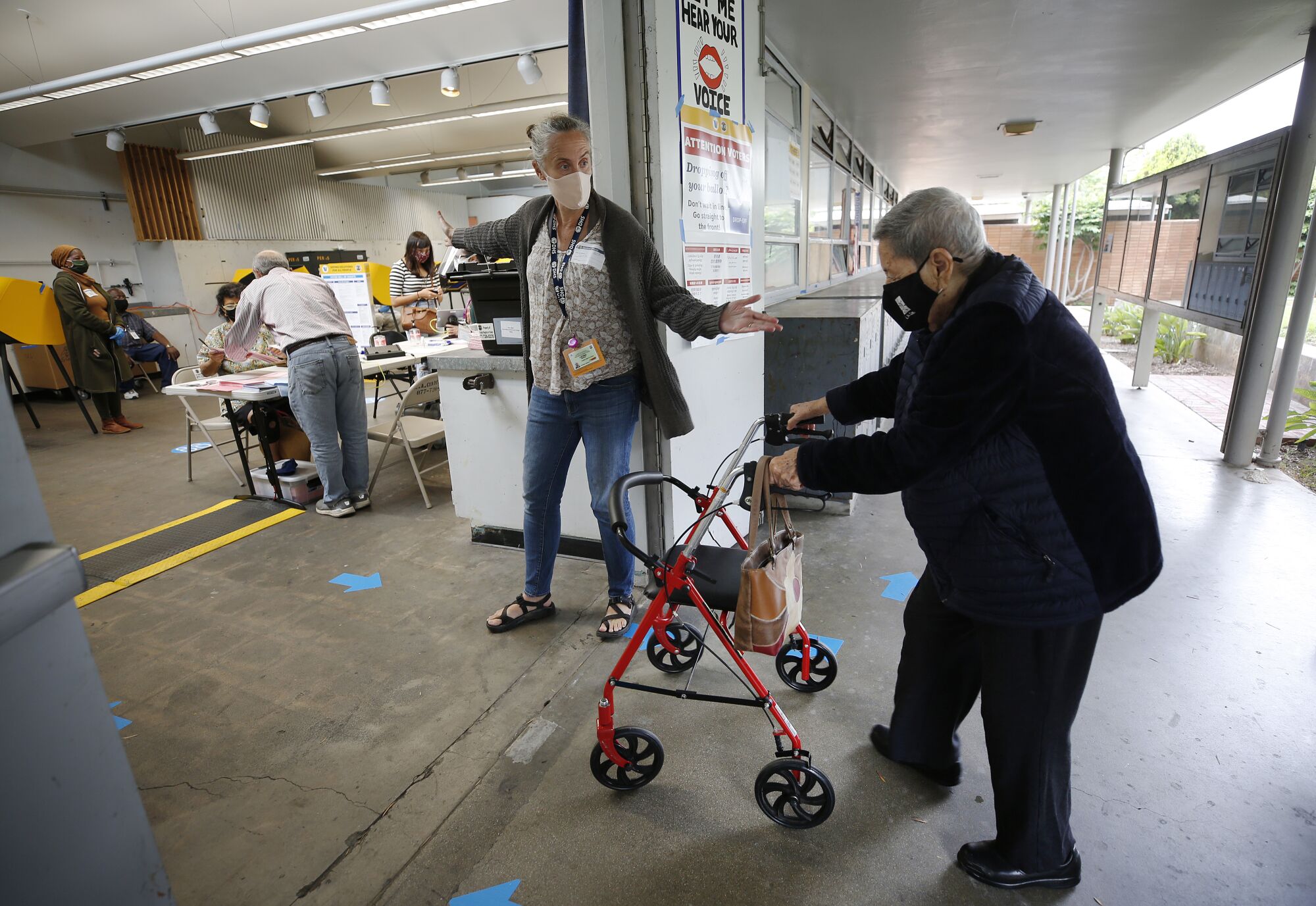 A person using a walker enters vote center