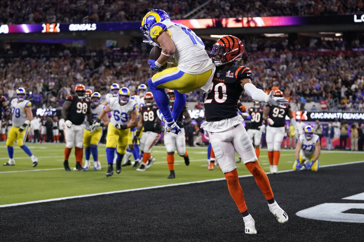 Los Angeles Rams wide receiver Cooper Kupp, top, catches a touchdown against Cincinnati Bengals cornerback Eli Apple during the second half of the NFL Super Bowl 56 football game Sunday, Feb. 13, 2022, in Inglewood, Calif. (AP Photo/Marcio Jose Sanchez)