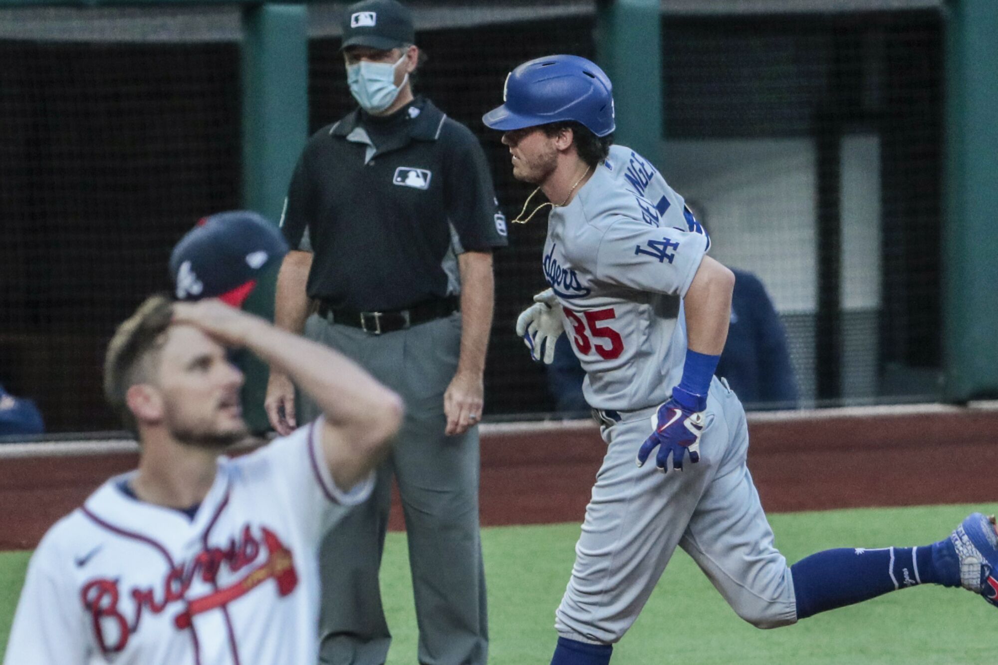 Dodgers center fielder Cody Bellinger circles the bases after hitting a home run off Braves relief pitcher Grant Dayton
