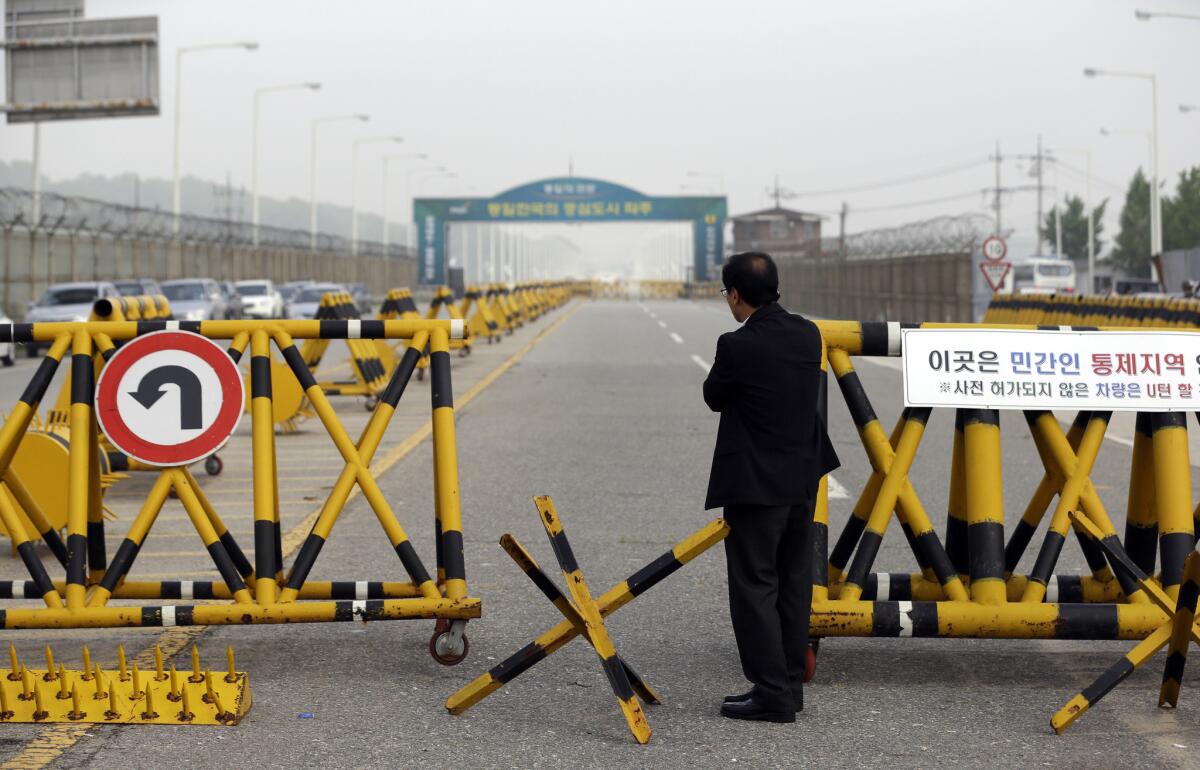 A South Korean who runs a factory in the joint Kaesong industrial complex between North and South stands outside military barricades set up on Unification Bridge near the border village of Panmunjom.