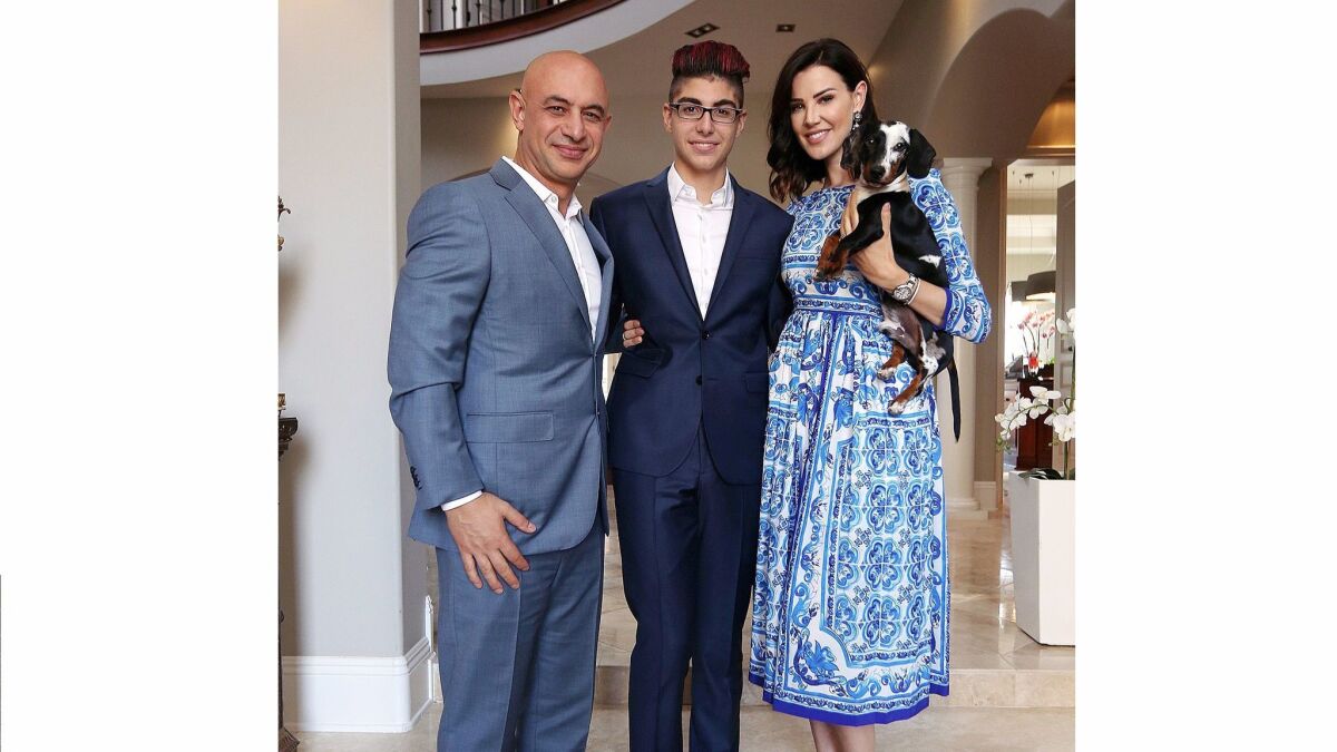 Steven Aghakhani, 14, center, with his father Armik, and step-mother Jennifer, and miniature dachshund Cooper.