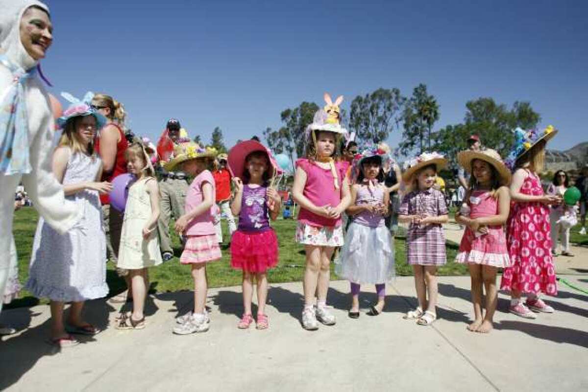 Children line up as they listen to the raffle prizes being called out during Easter in the Park, which took place at Memorial Park in La Canada on Saturday.