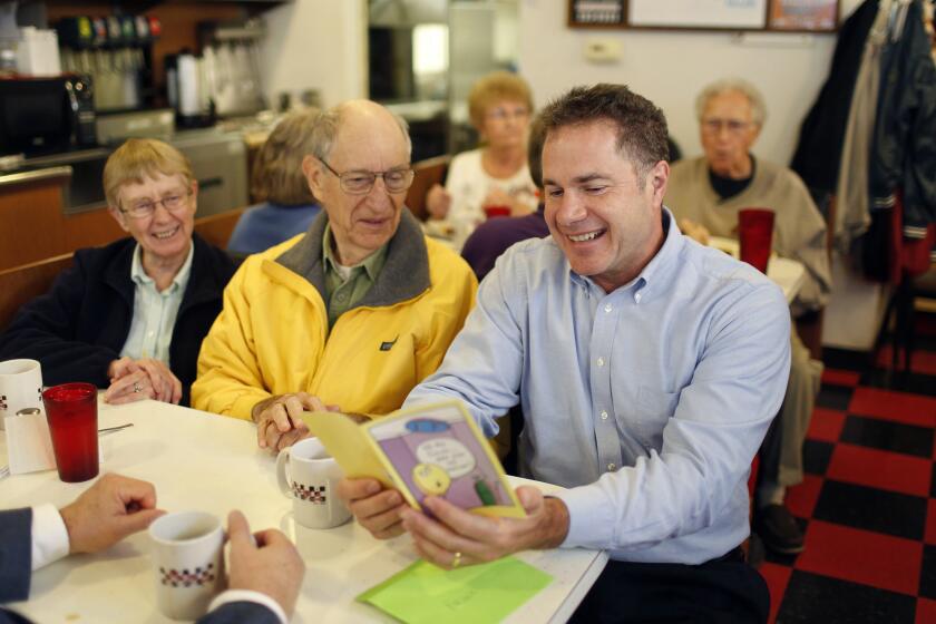 Rep. Bruce Braley, the Democratic candidate for Senate in Iowa, looks over a birthday card in an appearance Thursday at Morg's Diner in Waterloo.