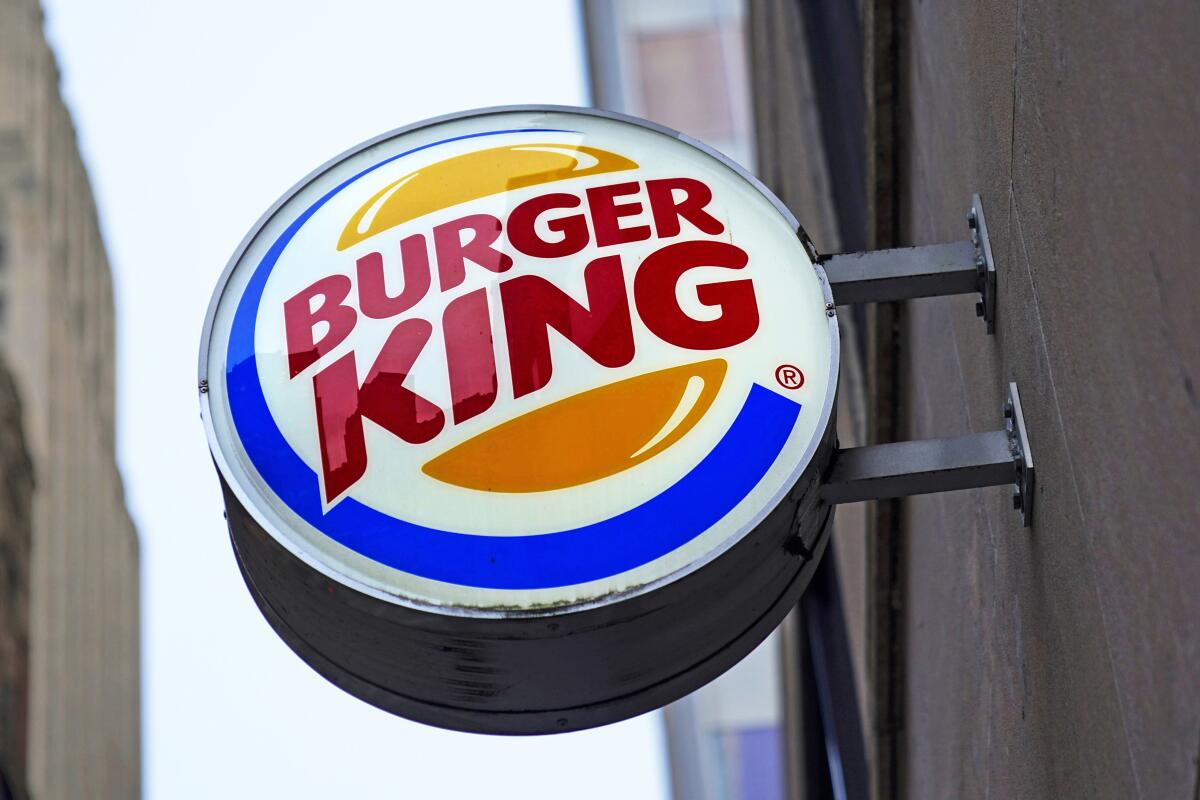 The Burger King logo is displayed on a sign outside a restaurant in downtown Pittsburgh