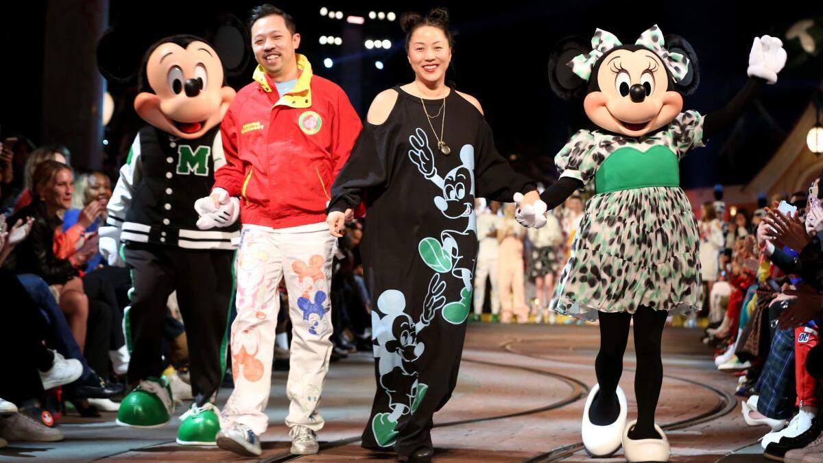 Mickey Mouse and co-founders of Open Ceremony Humberto Leon and Carol Lim along with Minnie Mouse close the Opening Ceremony spring 2018 show, which was staged at Disneyland in Ahaheim on Wednesday.