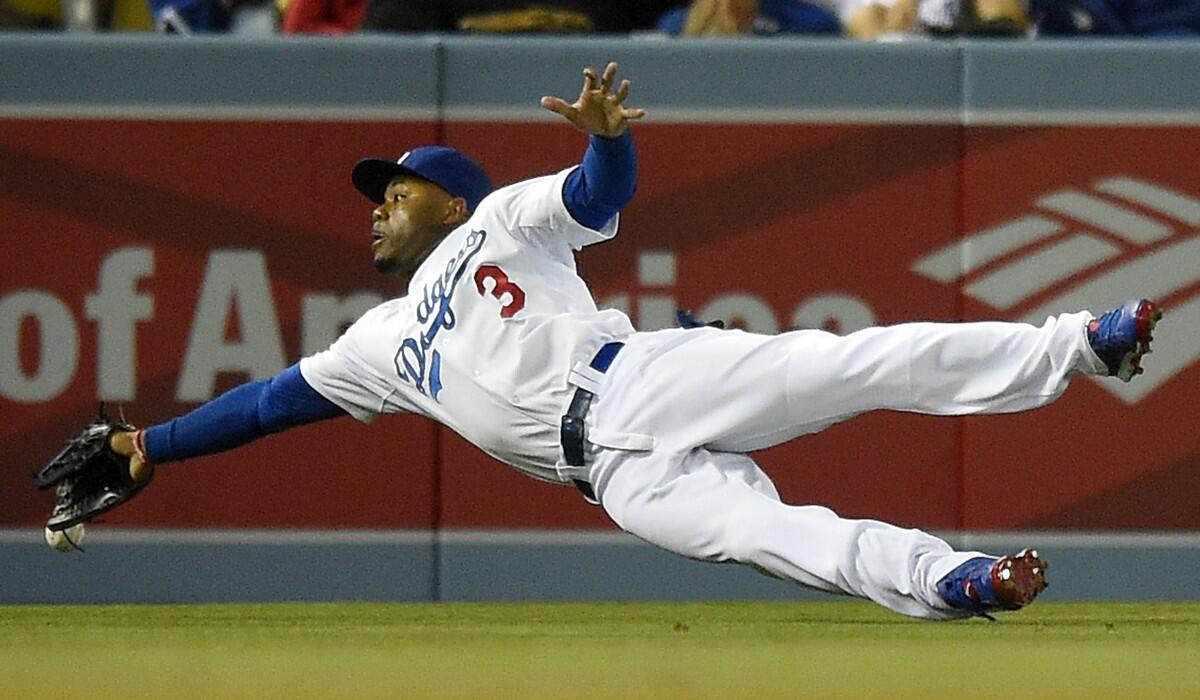 Dodgers left fielder Carl Crawford can't get to a ball hit by Phillies second baseman Chase Utley, who wound up with a double on the play, during a game last month at Dodger Stadium.