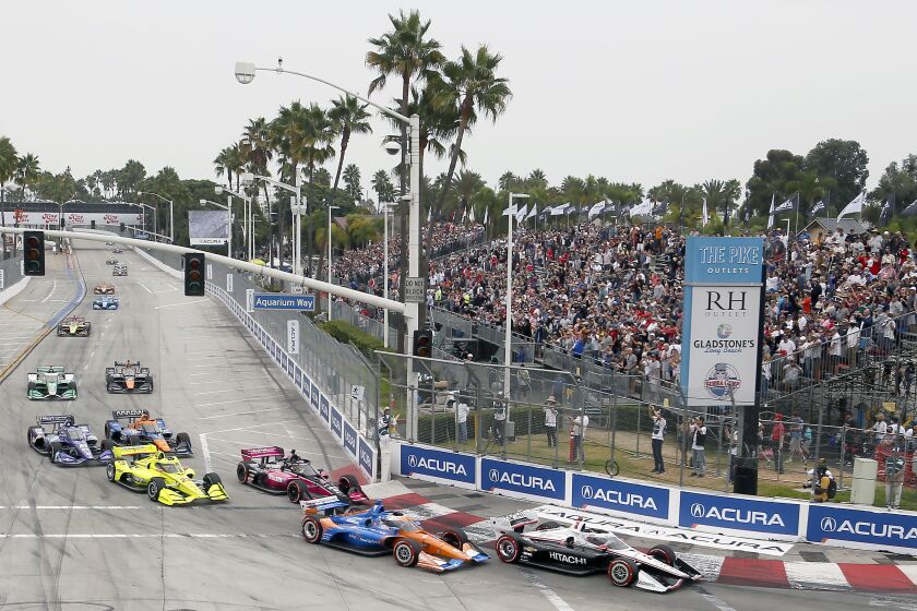 IndyCars begin the Grand Prix of Long Beach auto race into Turn 1 with Josef Newgarden (2) in the lead Sunday, Sept. 26, 2021, in Long Beach, Calif. (AP Photo/Alex Gallardo)