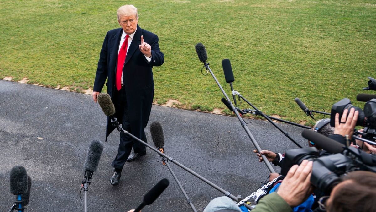 President Trump speaks to the media as he leaves the White House bound for his Mar-a-Lago resort in Florida on March 22.
