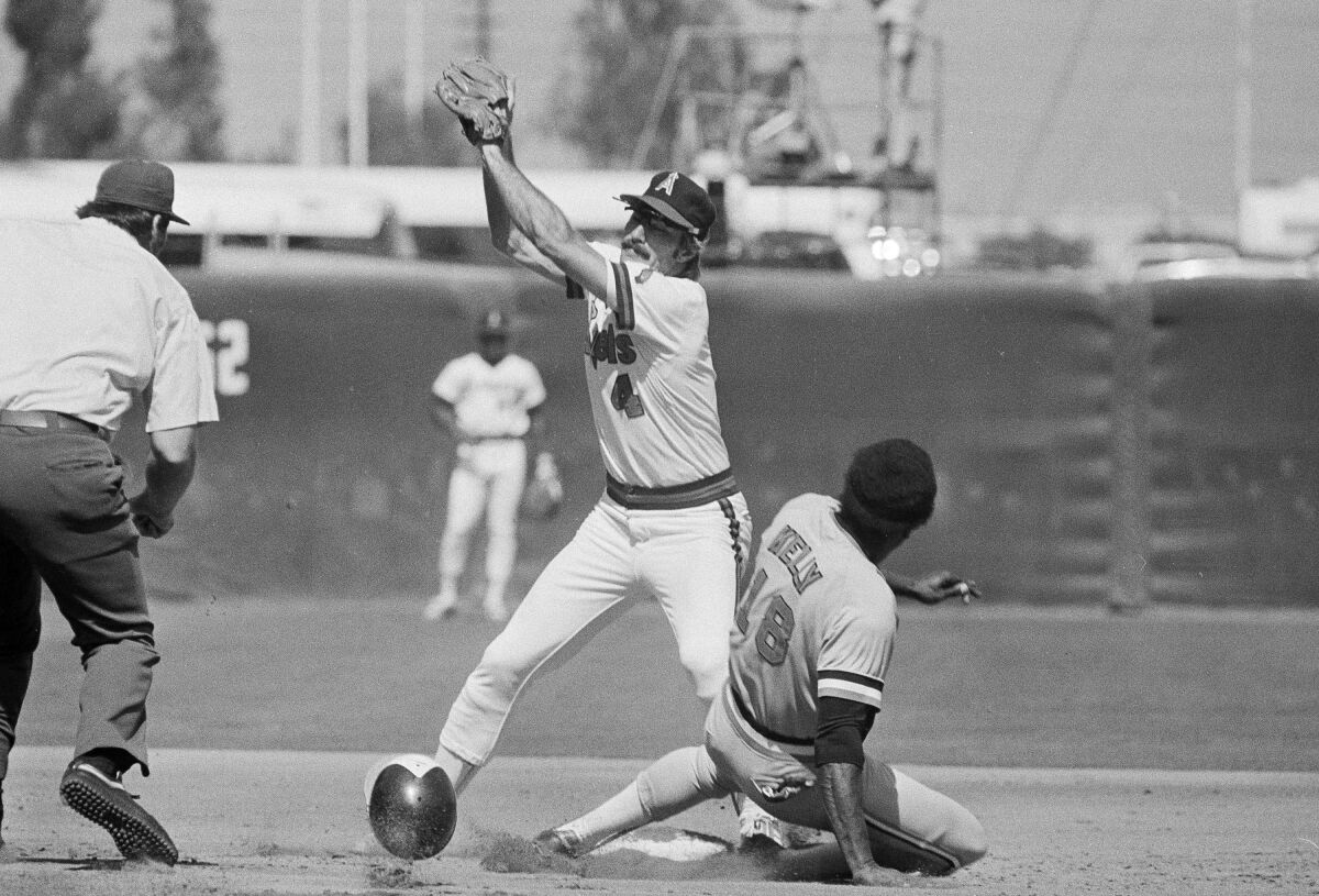 Angels second baseman Bobby Grich catches a throw in front of Baltimore Orioles baserunner Pat Kelly during a game in 1979.