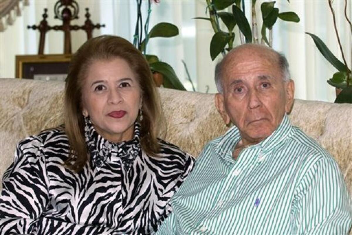 In this undated photo released by Carlos Andres Perez's family, Venezuela's former President Carlos Andres Perez, right, accompanied by his wife Cecilia Matos, poses for pictures at his home in Miami. Perez died on Saturday, Dec. 25, 2010, in Miami of a heart attack, his daughter Maria Francia Perez said. (AP Photo/Carlos Andres Perez's family)