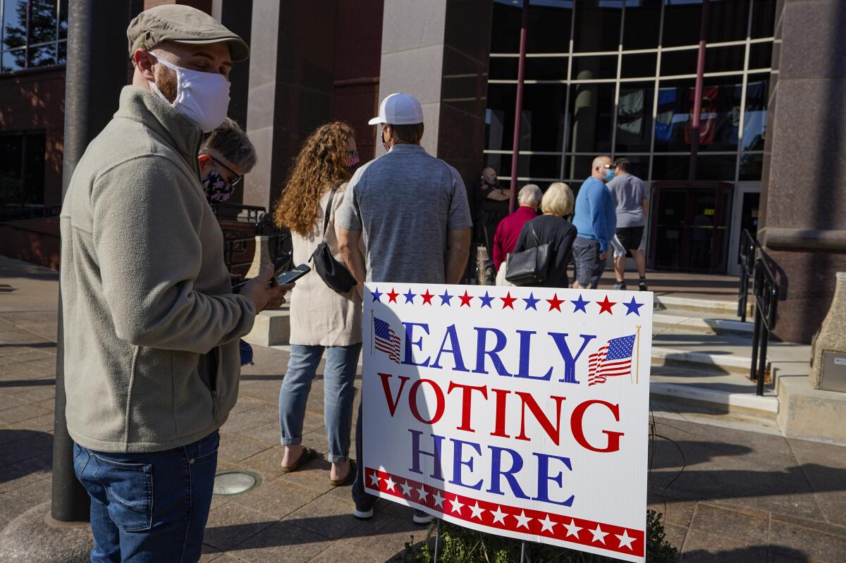 Voters wait in line at the Judicial Center in Noblesville, Indiana, on Oct. 7, four weeks before the election.
