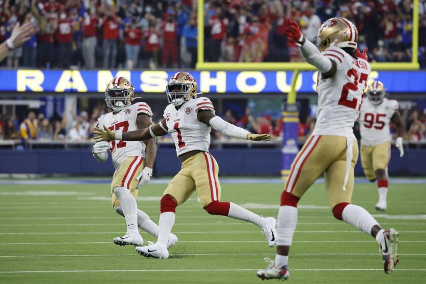 INGLEWOOD, CA - JANUARY 9, 2022: San Francisco 49ers outside linebacker Dre Greenlaw (57), San Francisco 49ers free safety Jimmie Ward (1) and San Francisco 49ers defensive back Dontae Johnson (27) react after San Francisco 49ers cornerback Ambry Thomas (20) seals the overtime win for the 49ers with a late game interception against Los Angeles Rams wide receiver Odell Beckham Jr. (3) on January 9, 2022 at SoFi Stadium in Inglewood, California.(Gina Ferazzi / Los Angeles Times)